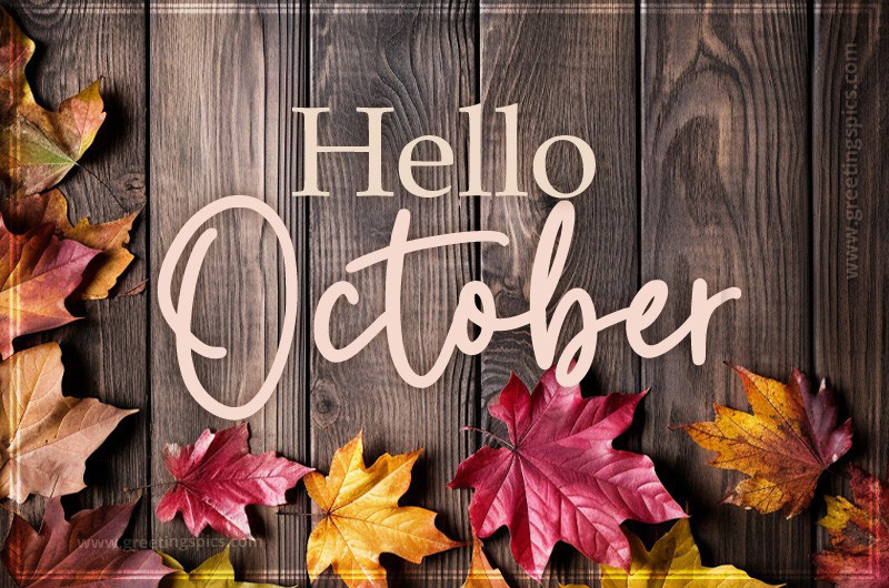 Hello October image with leaves on a wooden table